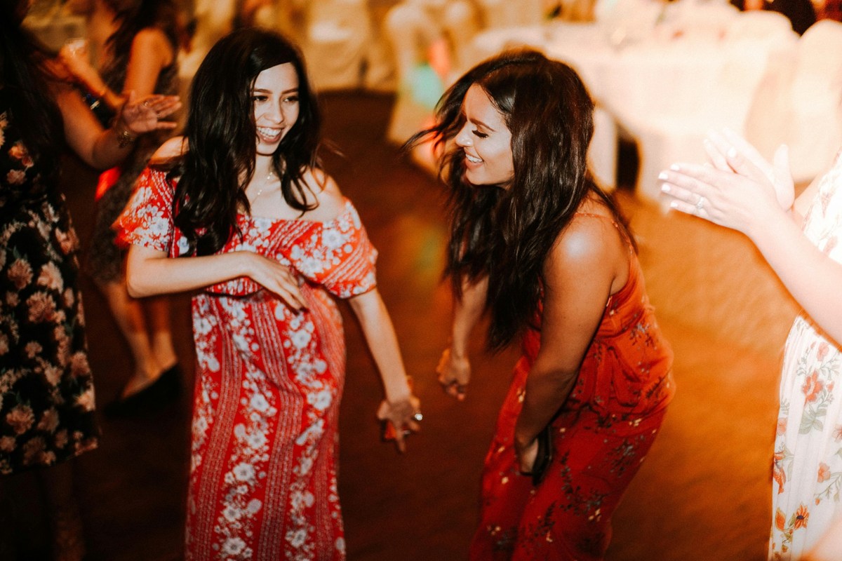 Two women dance in a nightclub.